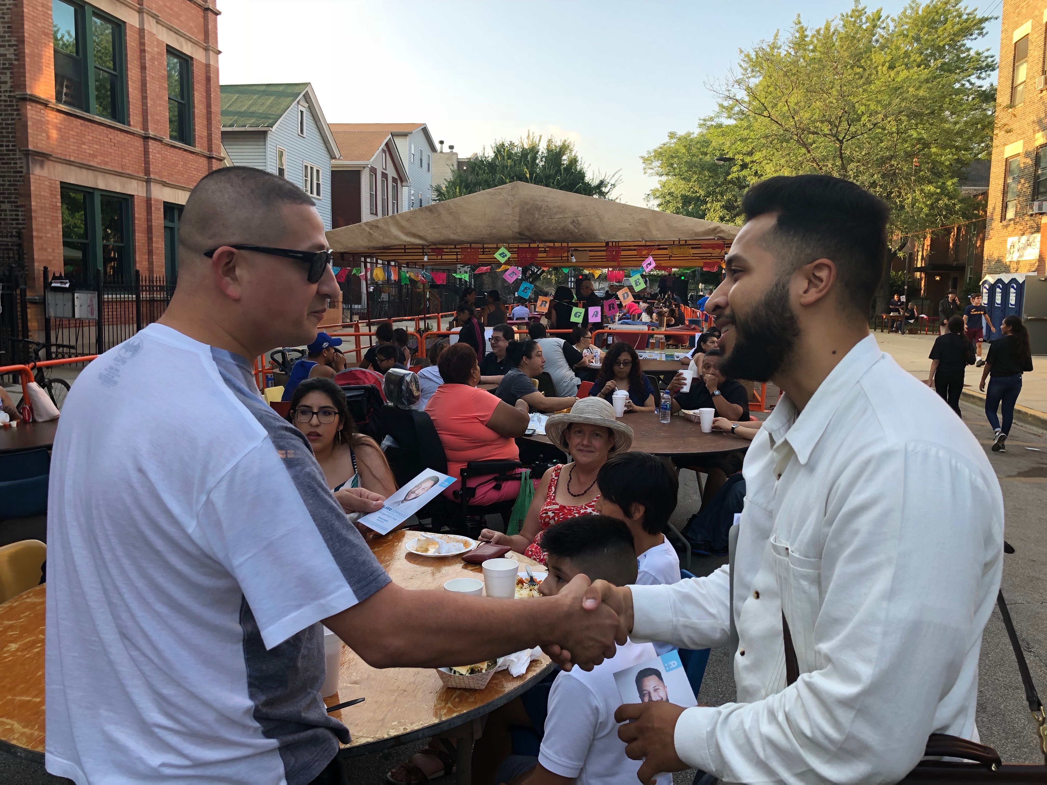 Hilario Dominguez shaking a constituent's hand